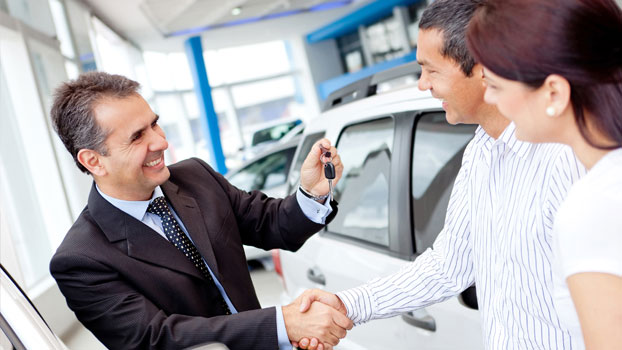 Couple listening to the appraiser for a used car sale