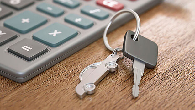 Car key placed next to a calculator